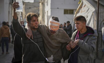 An injured man is taken to the Al-Ahli hospital following overnight Israeli army airstrikes across the Gaza Strip, in Gaza City, Tuesday, March 18, 2025. (AP Photo/Jehad Alshrafi).