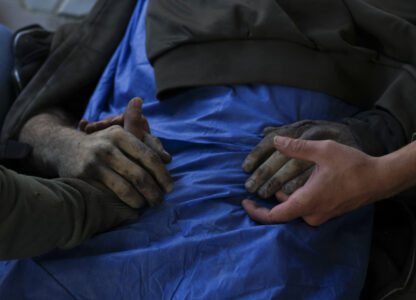 EDS NOTE: GRAPHIC CONTENT - EDS NOTE GRAPHIC CONTENT.- Palestinians hold the hands of their relative who was killed in an Israeli army airstrike, at Shifa Hospital in Gaza City, Tuesday, March 18, 2025. (AP Photo/Abdel Karem Hanna)