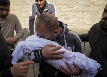 A Palestinian man holds the body of his 11 month-old nephew Mohammad Shaban, killed in an Israeli army airstrikes at the Al-Ahli Hospital in Gaza City, Tuesday, March 18, 2025. (AP Photo/Abdel Kareem Hana)