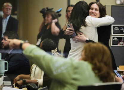 NASA employees react on Tuesday, March 18, 2025, at Johnson Space Center in Houston after watching astronauts splash down off the coast of Florida. (AP Photo/Ashley Landis)