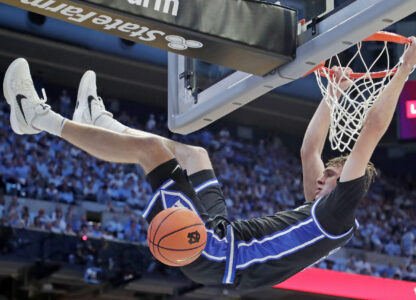 Duke forward Cooper Flagg (2) dunks during the second half of an NCAA college basketball game against North Carolina, Saturday, March 8, 2025, in Chapel Hill, N.C. (AP Photo/Chris Seward)