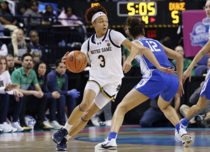 Notre Dame's Hannah Hidalgo (3) handles the ball as Duke's Delaney Thomas (12) defends during the second half of an NCAA college basketball game in the semifinals of the Atlantic Coast Conference tournament in Greensboro, N.C., Saturday, March 8, 2025. (AP Photo/Ben McKeown)