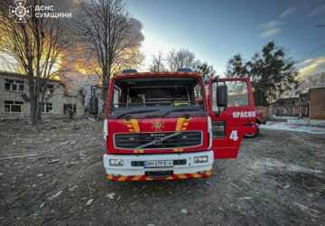 In this photo provided by the Ukrainian Emergency Service on Wednesday, March 19, 2025, firefighters' truck is parked on a site of a Russian attack in Krasnopillia, Sumy region, Ukraine. (Ukrainian Emergency Service via AP)