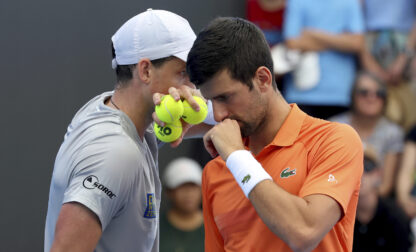 FILE - Canada's Vasek Pospisil and Serbia's Novak Djokovic talk tactics during their double match against during their Round of 32 match at the Adelaide International Tennis tournament in Adelaide, Australia, Jan. 2, 2023. (AP Photo/Kelly Barnes, File)