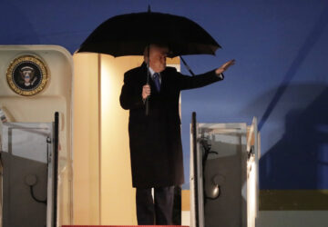 President Donald Trump waves from the stairs of Air Force One upon his arrival at Joint Base Andrews, Md., Monday, March 17, 2025. (AP Photo/Luis M. Alvarez)