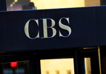 FILE - The CBS logo at the entrance to its headquarters, in New York Dec. 6, 2018. (AP Photo/Mark Lennihan, File)