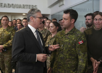 Britain's Prime Minister Keir Starmer speaks to a Canadian Lt Colonel as he visits a military base to meet planners mapping out next steps in the Coalition of the Willing in Northwood, London, Thursday, March 20, 2025.(AP Photo/Alastair Grant, Pool)