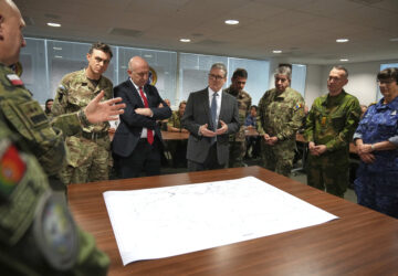 Britain's Prime Minister Keir Starmer and John Healey, Secretary of State for Defence, center left, listen as they visit a military base to meet planners mapping out next steps in the Coalition of the Willing in Greater London, Thursday, March 20, 2025.(AP Photo/Alastair Grant, Pool)