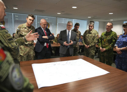 Britain's Prime Minister Keir Starmer and John Healey, Secretary of State for Defence, center left, listen as they visit a military base to meet planners mapping out next steps in the Coalition of the Willing in Greater London, Thursday, March 20, 2025.(AP Photo/Alastair Grant, Pool)