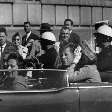 FILE - This Nov. 22, 1963 file photo shows President John F. Kennedy riding in motorcade with first lady Jacqueline Kenndy in Dallas, Texas. (AP Photo, file)