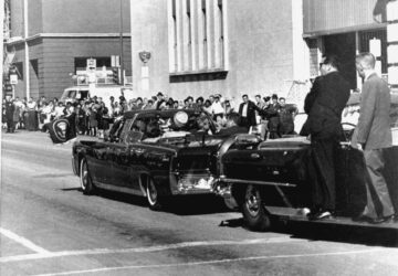 FILE - Secret servicemen standing on running boards follow the presidential limousine carrying President John F. Kennedy, right, rear seat, and first lady Jacqueline Kennedy, left, as well as Texas Gov. John Connally and his wife, Nellie, in Dallas, Texas, Nov. 22, 1963. (AP Photo/Jim Altgens, File)