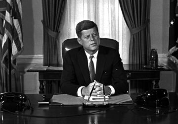 FILE - Newly-elected President Kennedy posed for first pictures at his White House desk, Jan. 21, 1961, before plunging into a busy round of conferences. (AP Photo/Bill Achatz, File)
