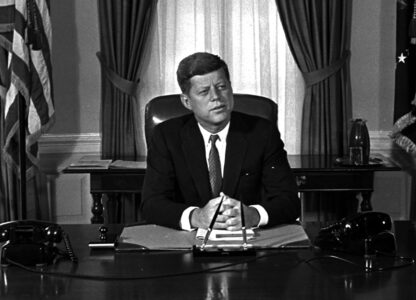 FILE - Newly-elected President Kennedy posed for first pictures at his White House desk, Jan. 21, 1961, before plunging into a busy round of conferences. (AP Photo/Bill Achatz, File)
