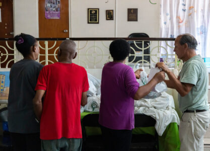 Volunteers at San Pablo Methodist Church pack food into bags to donate to the immigrant community in Barrio Obrero, San Juan, Puerto Rico, Friday, March 14, 2025. (AP Photo/Alejandro Granadillo)