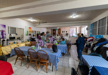 Pastor Nilka Marrero, right, and other San Pablo Methodist Church volunteers organize donations for the immigrant community in Barrio Obrero, San Juan, Puerto Rico, Friday, March 14, 2025. (AP Photo/Alejandro Granadillo)