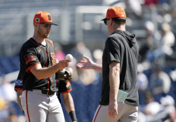 San Francisco Giants manager Bob Melvin, right, takes the ball from Giants starting pitcher Landen Roupp during the fourth inning of a spring training baseball game against the San Diego Padres, Tuesday, March 4, 2025, in Peoria, Ariz. (AP Photo/Ross D. Franklin)