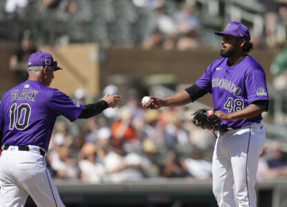 Colorado Rockies manager Bud Black (10) takes the ball from starting pitcher Germán Márquez (48) during the third inning of a spring training baseball game against the San Francisco Giants, Monday, March 10, 2025, in Scottsdale, Ariz. (AP Photo/Ross D. Franklin)