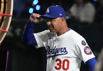Los Angeles Dodgers manager Dave Roberts walks on to the field during team introductions before an MLB Tokyo Series baseball game against the Chicago Cubs in Tokyo, Japan, Wednesday, March 19, 2025. (AP Photo/Eugene Hoshiko)