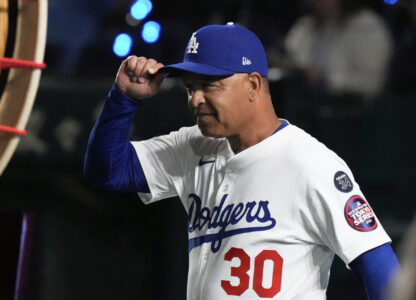 Los Angeles Dodgers manager Dave Roberts walks on to the field during team introductions before an MLB Tokyo Series baseball game against the Chicago Cubs in Tokyo, Japan, Wednesday, March 19, 2025. (AP Photo/Eugene Hoshiko)