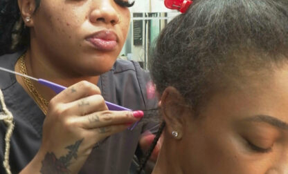 In this image from video, Jahzé Wyse braids a client's hair at her salon in Atlanta on Wednesday, March 19, 2025. (AP Photo/Javier Arciga)