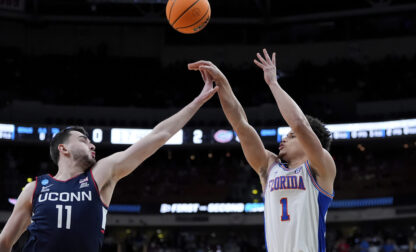 Florida guard Walter Clayton Jr. (1) shoots for three in front of Connecticut forward Alex Karaban (11) during the first half in the second round of the NCAA college basketball tournament, Sunday, March 23, 2025, in Raleigh, N.C. (AP Photo/Stephanie Scarbrough)