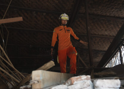 A rescuer works through rubble of a collapsed building following Friday's earthquake in Naypyitaw, Myanmar, Tuesday, April 1, 2025. (AP Photo)