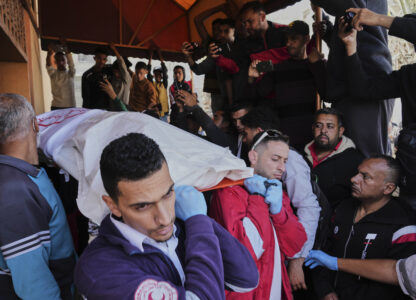 Mourners carry the bodies of 8 Red Crescent emergency responders, recovered in Rafah a week after an Israeli attack, as they are transported for burial from a hospital in Deir al-Balah, Gaza Strip, on Monday, March 31, 2025. (AP Photo/Abdel Kareem Hana)