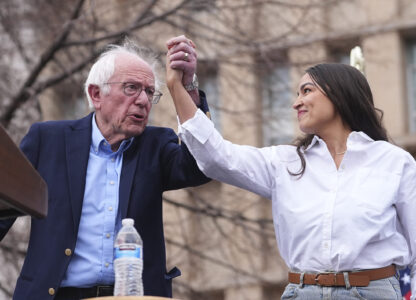 Sen. Bernie Sanders, I-Vt., left, greets Rep. Alexandria Ocasio-Cortez, D-N.Y., as they speak during a stop of their 