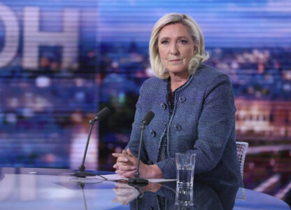 Far-right leader Marine Le Pen poses prior to an interview on the evening news broadcast of French TV channel TF1, after a French court convicted Marine Le Pen of embezzlement and barred her from seeking public office for five years, Monday, March 31, 2025, in Boulogne-Billancourt, outside Paris. (Thomas Samson, Pool via AP)