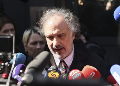 French far-right leader Marine Le Pen's lawyer Rodolphe Bosselut answers reporters outside the National Rally headquarters after a French court barred Marine Le Pen from seeking public office for five years, with immediate effect, for embezzlement, Monday, March 31, 2025 in Paris. (AP Photo/Thomas Padilla)