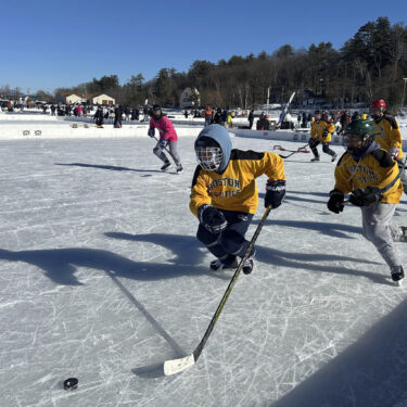 FILE - Hockey players go for the puck during the final of the women's open division at the pond hockey classic in Meredith, N.H., on Sunday, Feb. 4, 2024. (AP Photo/Nick Perry, File)