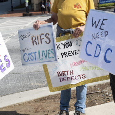 People protest outside of the Centers for Disease Control and Prevention in Atlanta on Tuesday, April 1, 2025 after layoffs were announced. (AP Photo/Ben Gray)