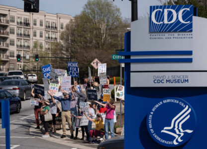 People protest in support of the Centers for Disease Control and Prevention in front of the headquarters in Atlanta, Tuesday, April 1, 2025 after layoffs were announced. (AP Photo/Ben Gray)