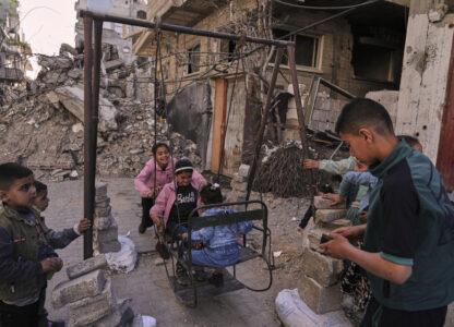 Palestinian children play on swings amid the rubble during Eid al-Fitr in Jabaliya, Gaza Strip, on Monday, March 31, 2025. (AP Photo/Jehad Alshrafi)