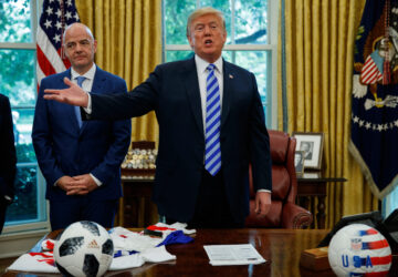 FILE - FIFA president Gianni Infantino, left, watches as President Donald Trump speaks to reporters during a meeting in the Oval Office of the White House, Aug. 28, 2018, in Washington. (AP Photo/Evan Vucci, File)