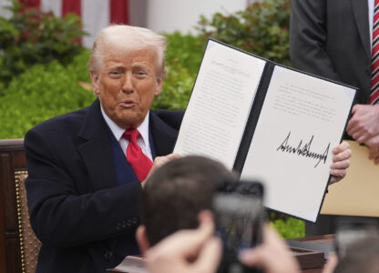 President Donald Trump holds a signed executive order during an event to announce new tariffs in the Rose Garden of the White House, Wednesday, April 2, 2025, in Washington. (AP Photo/Evan Vucci)