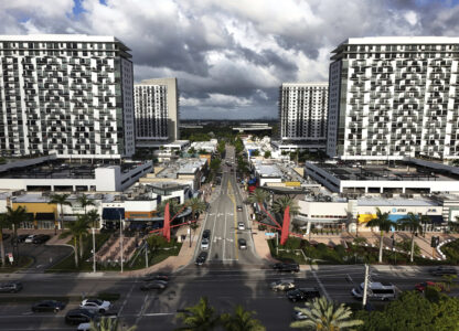 Cars pass through the area known as Downtown Doral, Saturday, April 5, 2025, in Doral, Fla. (AP Photo/Rebecca Blackwell)