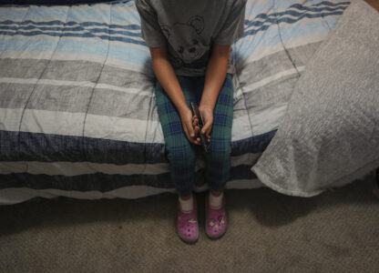 A 9-year-old girl with Temporary Protected Status, or TPS, who was born in Venezuela, but who fluently speaks only English and is in the gifted program at her school, watches TV in her family's apartment, Saturday, April 5, 2025, in Doral, Fla. (AP Photo/Rebecca Blackwell)