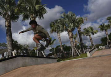 Reinaldo Schanz, a 19-year-old U.S. citizen who emmigrated from Venezuela at age 2, practices moves on his rollerblades after finishing work as a park service aide in Doral Central Park, Wednesday, April 2, 2025, in Doral, Fla. Schanz said his family supports the administration going after migrants with criminal records, but was surprised to see people on Temporary Protected Status (TPS) and similar programs targeted as well. (AP Photo/Rebecca Blackwell)