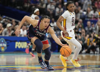 UConn guard Azzi Fudd (35) brings the ball up court during the first half of the national championship game at the Final Four of the women's NCAA college basketball tournament, Sunday, April 6, 2025, in Tampa, Fla. (AP Photo/Chris O'Meara)