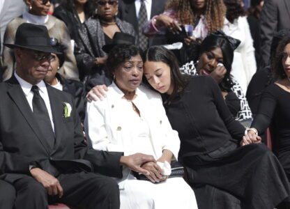Marie and Maxum Bourdeau, left, attend the memorial service of their daughter, former U.S. Rep. Mia Love, with their granddaughters Abigale, center right, and Alessa, far right, at The Church of Jesus Christ of Latter-day Saints on the University of Utah campus in Salt Lake City, Monday, April 7, 2025. (AP Photo/Melissa Majchrzak)