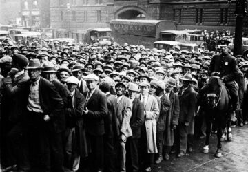 FILE - Thousands of unemployed people gather outside City Hall in Cleveland during the Great Depression, after some 2,000 jobs were made available for park improvements and repairs, Oct. 9, 1930. (AP Photo, File)