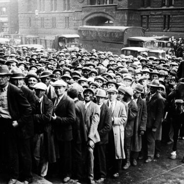 FILE - Thousands of unemployed people gather outside City Hall in Cleveland during the Great Depression, after some 2,000 jobs were made available for park improvements and repairs, Oct. 9, 1930. (AP Photo, File)