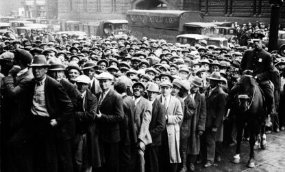 FILE - Thousands of unemployed people gather outside City Hall in Cleveland during the Great Depression, after some 2,000 jobs were made available for park improvements and repairs, Oct. 9, 1930. (AP Photo, File)