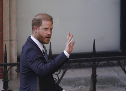 Prince Harry waves as he arrives at the High Court in London, England, Tuesday, April 8, 2025. (AP Photo/Alberto Pezzali)