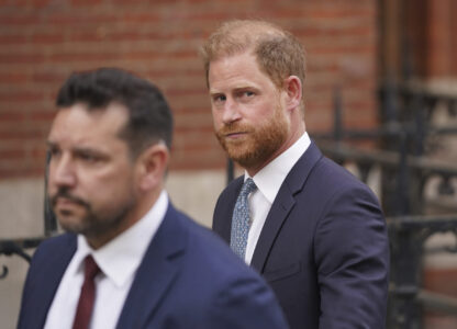 Britain's Prince Harry looks at the media as he leaves the Royal Courts of Justice in London, Tuesday, April 8, 2025. (AP Photo/Alberto Pezzali)