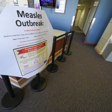 FILE - A measles sign is seen at the Texas Tech University Health Sciences Center, Feb. 25, 2025, in Lubbock, Texas. (AP Photo/Julio Cortez, file)