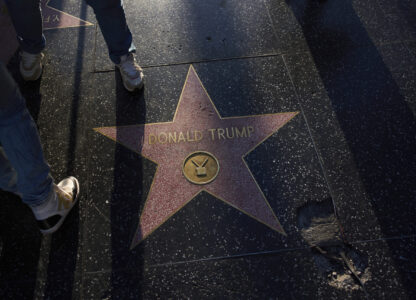 Tourists take pictures with the Donald Trump star on the Hollywood Walk of Fame in Los Angeles, Friday, April 4, 2025. (AP Photo/Jae C. Hong)