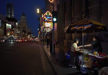 A hot dog vendor takes money from a customer on the Hollywood Walk of Fame in Los Angeles, Friday, April 4, 2025. (AP Photo/Jae C. Hong)