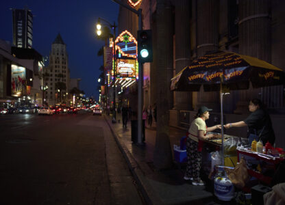 A hot dog vendor takes money from a customer on the Hollywood Walk of Fame in Los Angeles, Friday, April 4, 2025. (AP Photo/Jae C. Hong)
